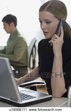 Stock Image - Businesswoman talking on telephone. Fotosearch