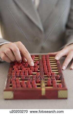 Businesswoman using abacus View Large Photo Image Stock Image - Businesswoman using abacus. Fotosearch