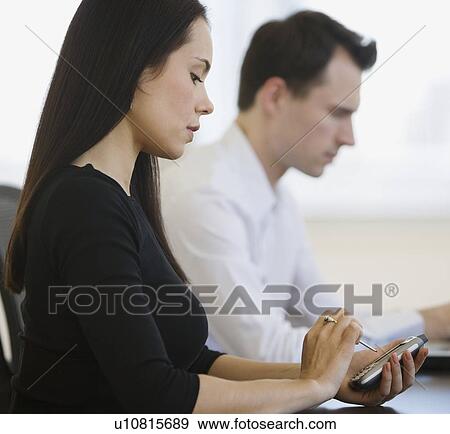 Businesswoman using electronic organizer View Large Photo Image Stock Photo - Businesswoman using electronic organizer. Fotosearch
