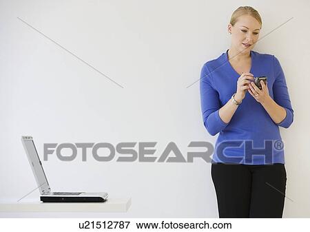 Businesswoman using electronic organizer View Large Photo Image Stock Photo - Businesswoman using electronic organizer. Fotosearch