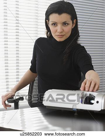 Businesswoman using projector View Large Photo Image Stock Image - Businesswoman using projector. Fotosearch