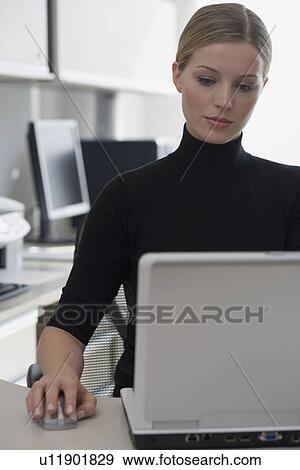Stock Photo - Businesswoman using wireless computer mouse. Fotosearch