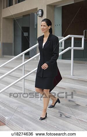 Businesswoman walking down outdoor stairs View Large Photo Image Stock Photograph - Businesswoman walking down outdoor stairs. Fotosearch