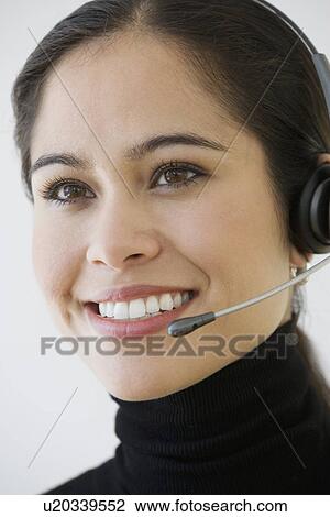 Businesswoman wearing headset View Large Photo Image Stock Image - Businesswoman wearing headset. Fotosearch
