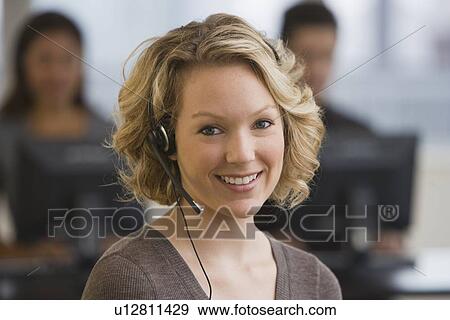 Stock Photo - Businesswoman wearing headset. Fotosearch
