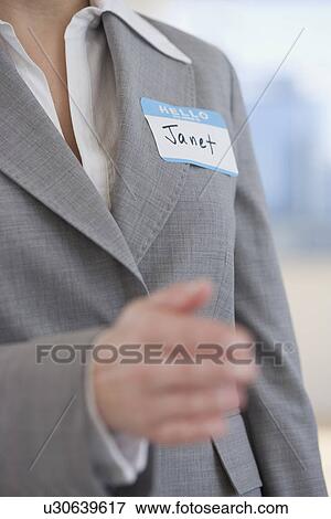 Businesswoman wearing Hello My Name Is sticker View Large Photo Image Stock Photo - Businesswoman wearing Hello My Name Is sticker. Fotosearch