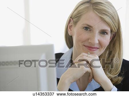 Businesswoman with hands clasped View Large Photo Image Stock Photo - Businesswoman with hands clasped. Fotosearch