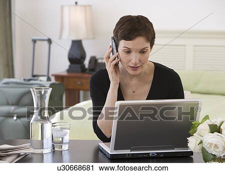 Businesswoman working in hotel room View Large Photo Image Stock Image - Businesswoman working in hotel room. Fotosearch