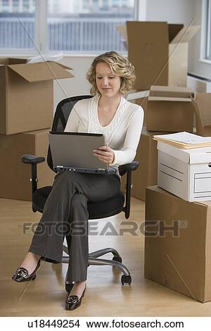 Businesswoman working in new office View Large Photo Image Picture - Businesswoman working in new office. Fotosearch
