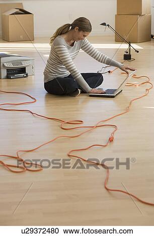 Stock Image - Businesswoman working in new office. Fotosearch