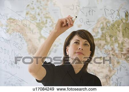 Businesswoman writing on dry erase board View Large Photo Image Stock Photo - Businesswoman writing on dry erase board. Fotosearch