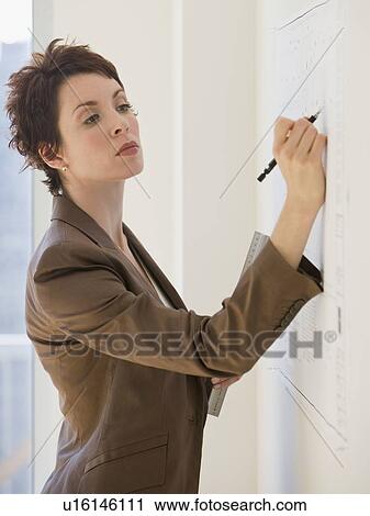 Businesswoman writing on wall chart View Large Photo Image Stock Image - Businesswoman writing on wall chart. Fotosearch