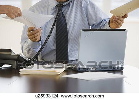 Busy businessman at desk View Large Photo Image Picture - Busy businessman at desk. Fotosearch