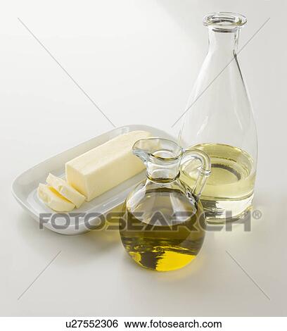Stock Photograph - Butter, oil and water on table. Fotosearch