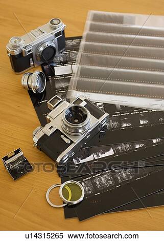 Cameras, negatives and contact sheets on table View Large Photo Image Stock Photography - Cameras, negatives and contact sheets on table. Fotosearch