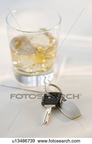 Stock Photo - Car keys next to cocktail. Fotosearch