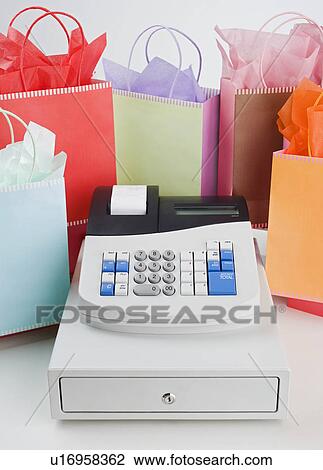 Cash register surrounded by gift bags View Large Photo Image Stock Image - Cash register surrounded by gift bags. Fotosearch