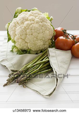 Cauliflower, tomatoes and asparagus on table View Large Photo Image Stock Image - Cauliflower, tomatoes and asparagus on table. Fotosearch