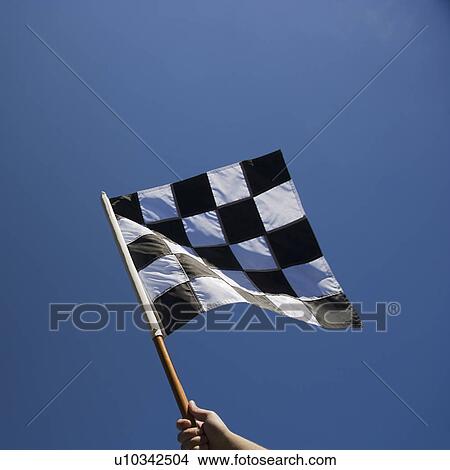 Picture - Checkered flag with blue sky. Fotosearch