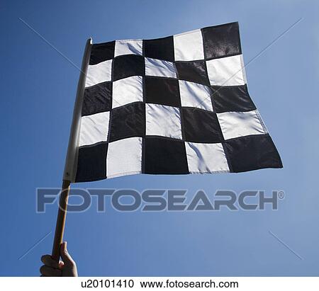Stock Image - Checkered flag with blue sky. Fotosearch