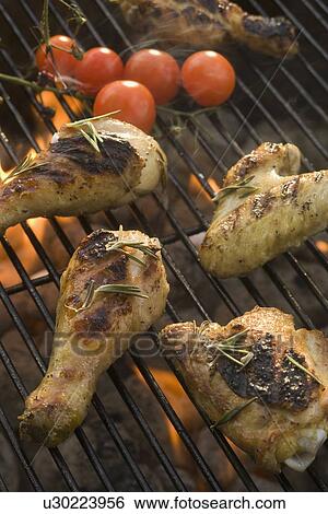 Stock Photograph - Chicken pieces cooking on grill. Fotosearch