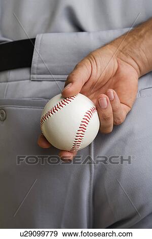 Close up baseball pitcher holding baseball behind back View Large Photo Image Stock Photo - Close up baseball pitcher holding baseball behind back. Fotosearch
