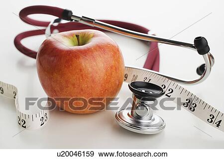 Close up of apple, tape measure and stethoscope View Large Photo Image Stock Photo - Close up of apple, tape measure and stethoscope. Fotosearch
