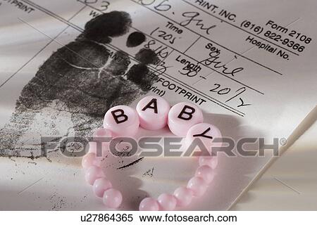 Stock Photography - Close up of baby bracelet and birth certificate. Fotosearch