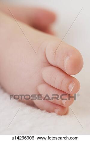 Stock Photograph - Close up of baby’s foot. Fotosearch