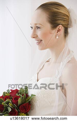 Stock Photo - Close up of bride holding bouquet. Fotosearch