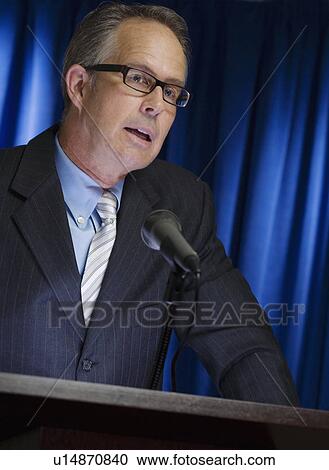 Close up of businessman speaking at podium View Large Photo Image Stock Image - Close up of businessman speaking at podium. Fotosearch