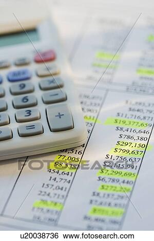 Stock Photograph - Close up of calculator on sheet of numbers. Fotosearch