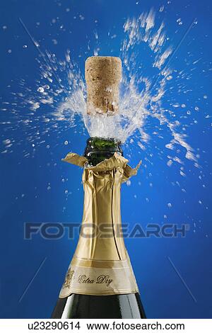 Picture - Close up of champagne cork popping. Fotosearch