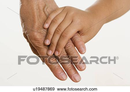 Close up of child holding adults hand View Large Photo Image Stock Photo - Close up of child holding adults hand. Fotosearch