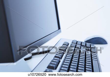 Stock Image - Close up of computer on desk. Fotosearch