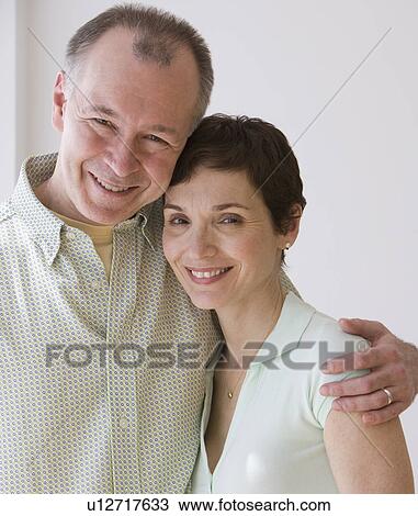 Stock Image - Close up of couple hugging. Fotosearch
