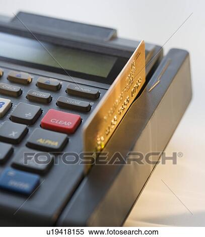 Stock Photography - Close up of credit card machine and credit card. Fotosearch