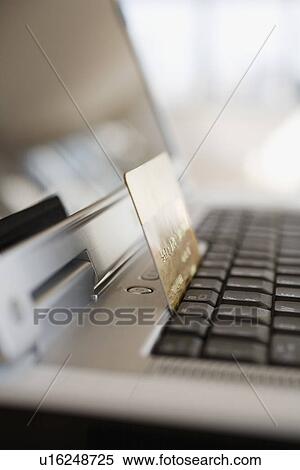 Close up of credit card on laptop View Large Photo Image Stock Photography - Close up of credit card on laptop. Fotosearch
