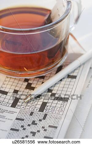 Close up of crossword puzzle and tea View Large Photo Image Stock Photograph - Close up of crossword puzzle and tea. Fotosearch