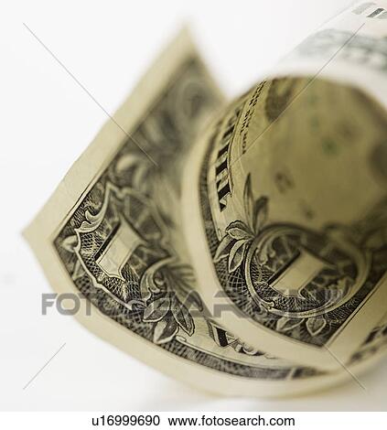 Stock Image - Close up of curled dollar bill. Fotosearch
