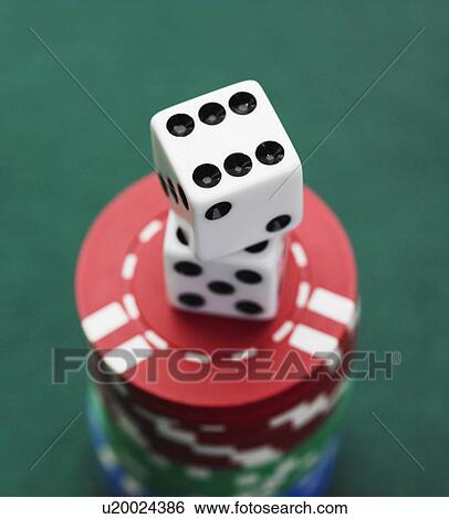 Stock Photograph - Close up of dice on stack of poker chips. Fotosearch