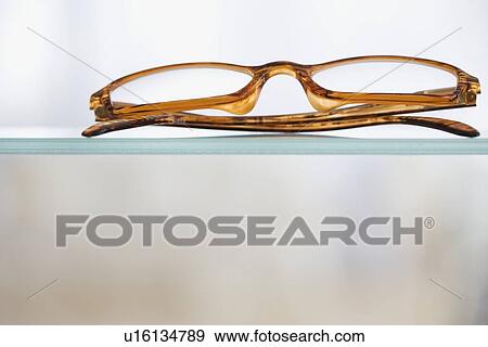Close up of eye glasses on shelf View Large Photo Image Stock Photo - Close up of eye glasses on shelf. Fotosearch