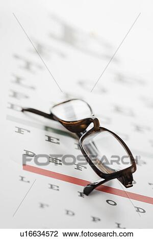 Close up of eyeglasses on eye chart View Large Photo Image Stock Image - Close up of eyeglasses on eye chart. Fotosearch