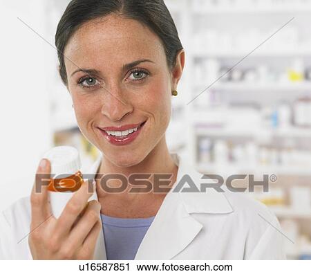 Close up of female pharmacist holding medication View Large Photo Image Stock Image - Close up of female pharmacist holding medication. Fotosearch