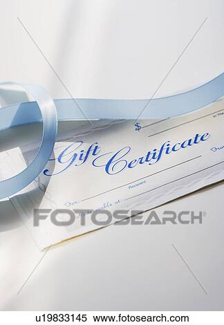 Stock Photography - Close up of gift certificate and ribbon. Fotosearch
