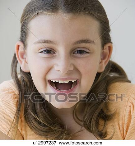 Stock Photo - Close up of girl laughing. Fotosearch