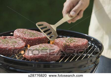 Close up of hamburgers on barbecue grill View Large Photo Image Stock Image - Close up of hamburgers on barbecue grill. Fotosearch
