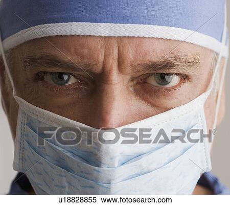 Stock Photography - Close up of male doctor wearing surgical mask. Fotosearch