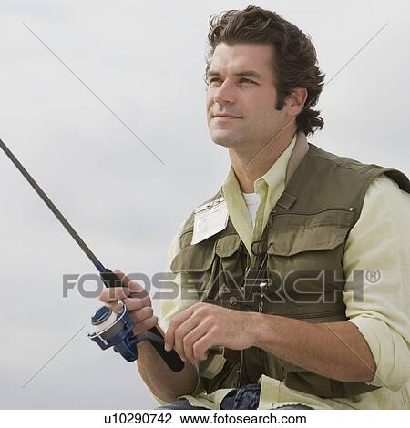 Stock Image - Close up of man fishing. Fotosearch