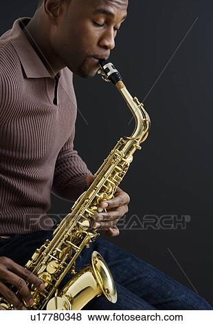 Stock Photo - Close up of man playing saxophone. Fotosearch